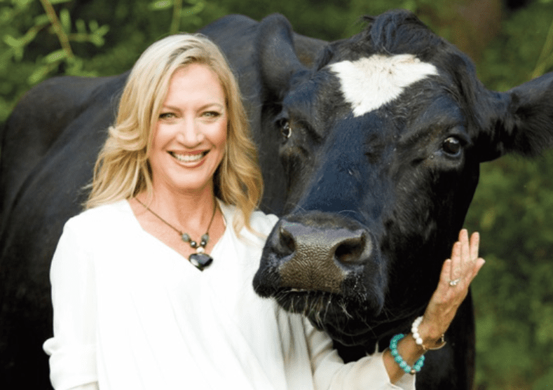 Alaqua Founder Laurie Hood poses with cow